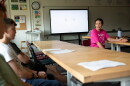 Amanda Valliere, right, talks to students in her civics and economics class during freshman orientation at Lebanon High School in Lebanon, N.H., on Tuesday, Aug. 25, 2026. Valliere told students that one of the first topics they will be discussing in the class is AI, and she asked them to think about their feelings on the subject. (Valley News photo)