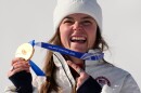 United States' Breezy Johnson shows her gold medal in the alpine ski women's downhill race, at the 2026 Winter Olympics, in Cortina d'Ampezzo, Italy, Sunday, Feb. 8, 2026.