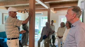 Guilford resident Jay Gustafson talking about his affordable, net-zero home in the Great Hill Cottage Community with Gov. Ned Lamont July 30, 2025.