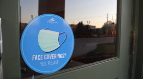 A face covering sign outside a building in Garden City, Kansas, during the pandemic.