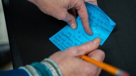 A person with lived experience of addiction writes down their thoughts on how opioid settlement funds should be spent in Mississippi during a listening session hosted by the Gulf States Newsroom at James Moore’s bike shop in Hattiesburg, Mississippi, on January 28, 2026.