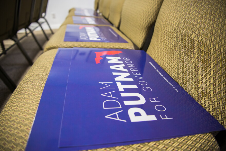 Adam Putnam campaign signs await Southwest Florida Republicans on the seats at the Lee County Republican Party debate watch party Aug. 8.