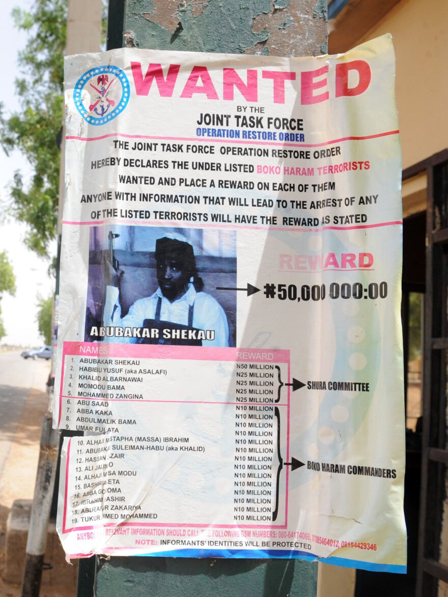 A poster in the northeastern city of Maiduguri shows a photograph of Abubakar Shekau, a Boko Haram leader who has claimed responsibility for recent attacks. The U.S. has placed a $7 million bounty on Shekau.