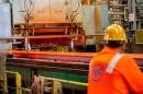 A U.S. Steel worker watches as a slab of steel moves through the production process. 