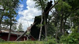A section of roof lies against a tree following a Wednesday, June 12, 2024, tornado that touched down near Clamshell Lake in the western Whitefish Chain of Lakes.
