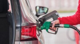 Woman putting gasoline in tank