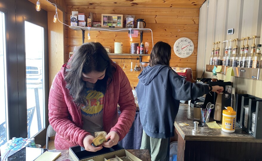 Denali Bybee and Avery Nelson work a shift at the Igiugig airport's student-run coffee shop. Jan. 18, 2023.