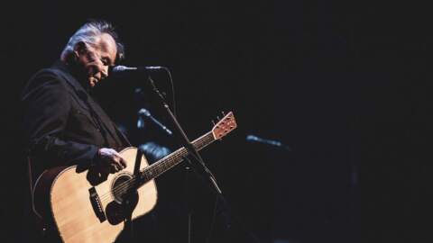 John Prine plays guitar. (Courtesy of Abramorama, Oh Boy Pictures and Radicalmedia)