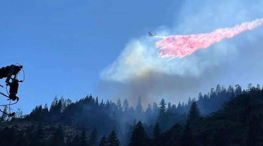 A Cal Fire tanker plane drops retardant on the Dixie Fire near Pulga on July 13, 2021.