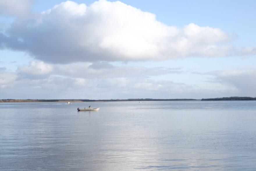 A man untangles his net in his boat on the Kuskokwim River in Bethel on Oct. 10, 2023.