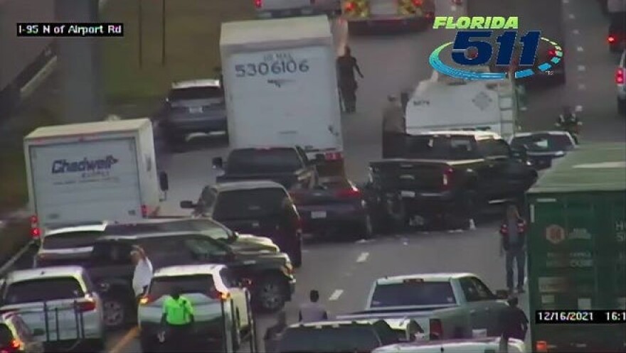 Damaged vehicles sit on Interstate 95 after a multivehicle crash shut down the highway on Thursday.