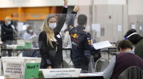 Recount observers raise hands during a Milwaukee hand recount of Presidential votes at the Wisconsin Center, Friday, Nov. 20, 2020, in Milwaukee, Wis.