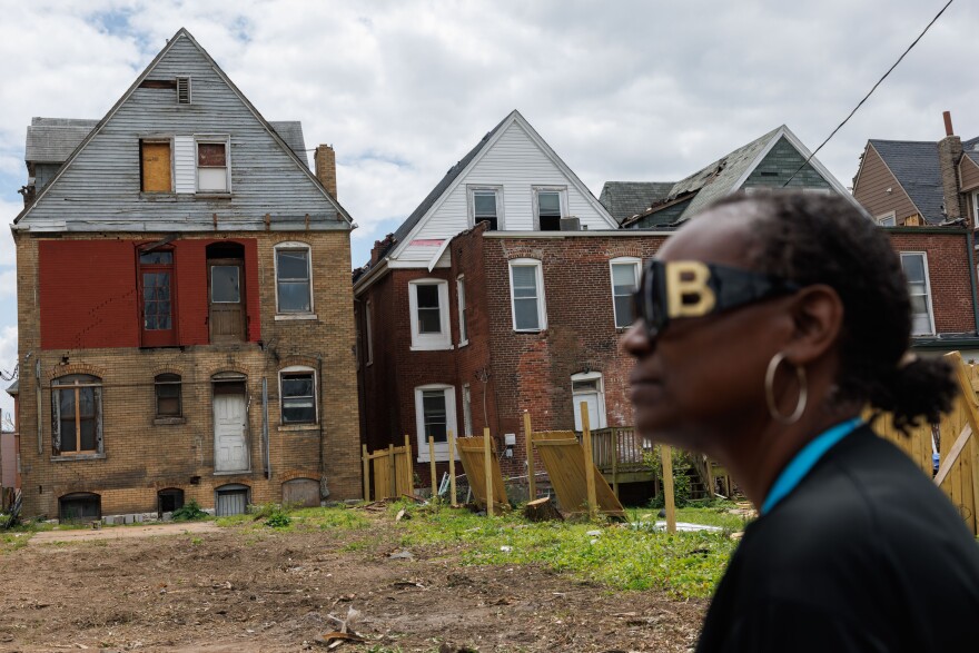 Sandra Harris, 58, looks towards the back of her tornado-damaged retirement home where her two-story back porch used to be May 28, 2025 on Enright Avenue in St. Louis, Missouri.