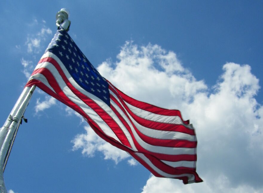 American flag fluttering against a blue sky