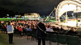 Event participants held candles during the Cascades Park "Hope, Healing, Harmony" memorial.