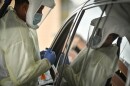 Tyrone Tyner, a medical assistant at Truman Medical Center prepares a drive through patient for a COVID-19 test on Oct. 28.