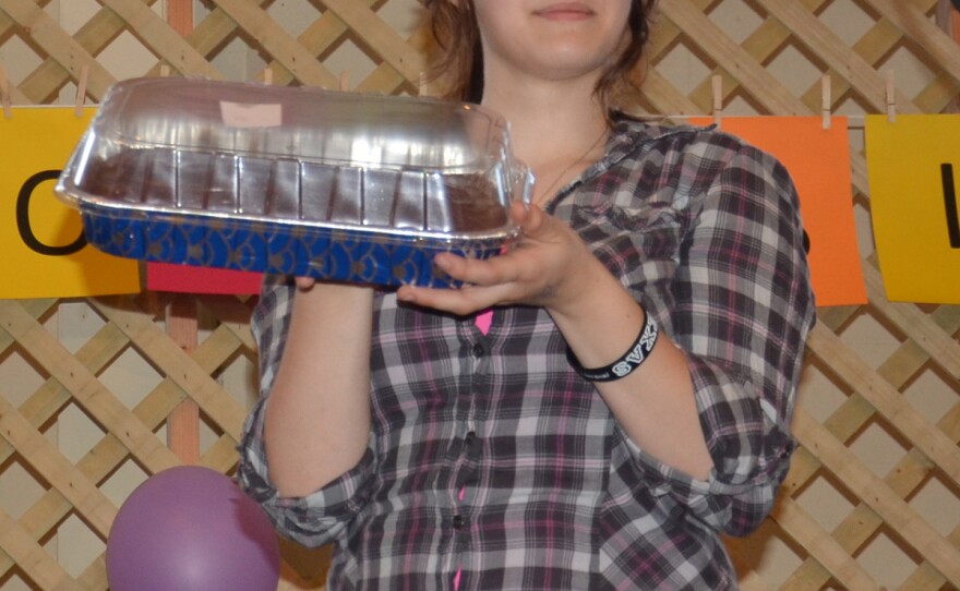 Courtney Poole, granddaughter of a cancer survivor, helps with the Cake Auction at Saturday's American Cancer Society benefit in Cooper.