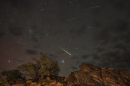Meteors from the Perseids Meteor Shower streak across a partly cloudy sky above Inyo National Forest in Bishop, California, in 2024.