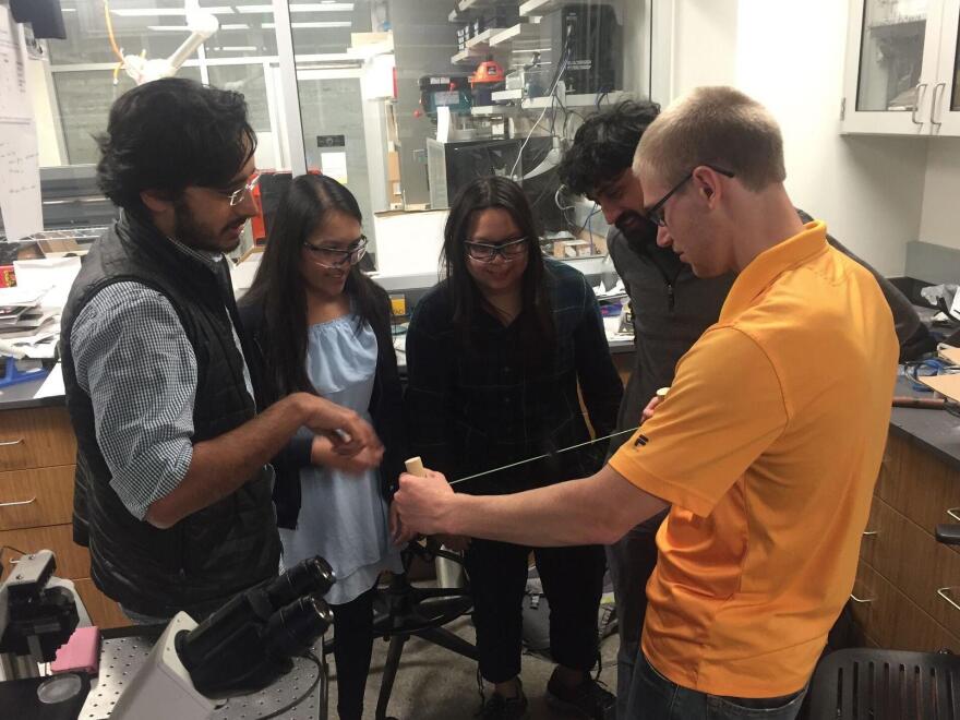The paperfuge team works on the newest prototype. They include (from left) Saad Bhamla, Aanchal Johri, Chew Chai, Manu Prakash and Brandon Benson.
