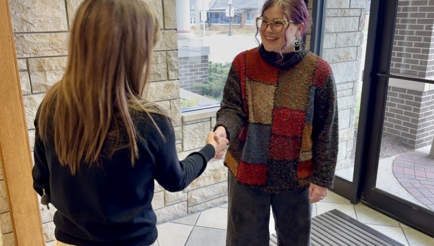 City of Chelsea community social worker Emilee Fetters (right) shakes hands with a resident.