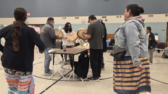Attendees participate in a round dance in the former Central Elementary School gym, as a soft launch for the Minwaadizi Project's Bemidji space on March 20, 2026.