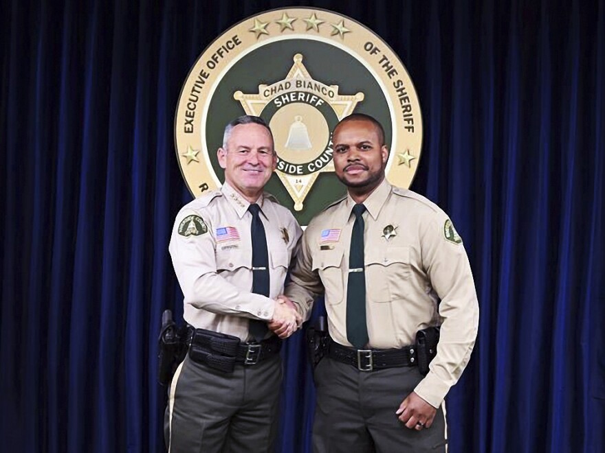 Riverside County Deputy Darnell Calhoun (right) poses with Sheriff Chad Biano in an undated photo. Calhoun was shot and killed Friday, just two weeks after another deputy in the department was slain in the line of duty.