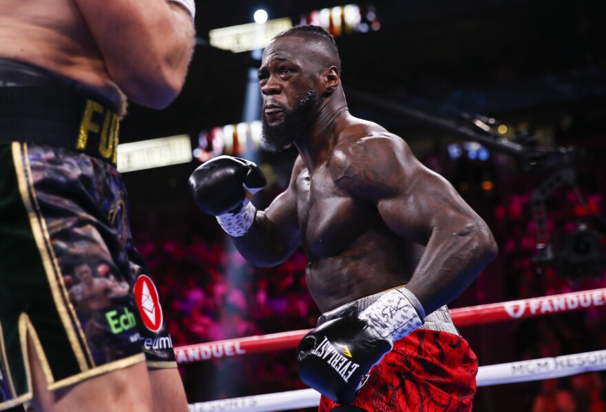 FILE -Deontay Wilder, right, fights Tyson Fury in a heavyweight championship boxing match Oct. 9, 2021, in Las Vegas. Wilder still has big plans and a bigger right hand, just like when he was heavyweight champion. He wants to be there again. His climb starts Saturday, Oct. 15, 2022, when he returns from consecutive losses to Tyson Fury to fight Robert Helenius at Brooklyn's Barclays Center. (AP Photo/Chase Stevens, File)