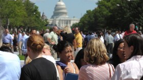 People gather on Freedom Plaza in Washington, D.C., after a earthquake on Tuesday.
