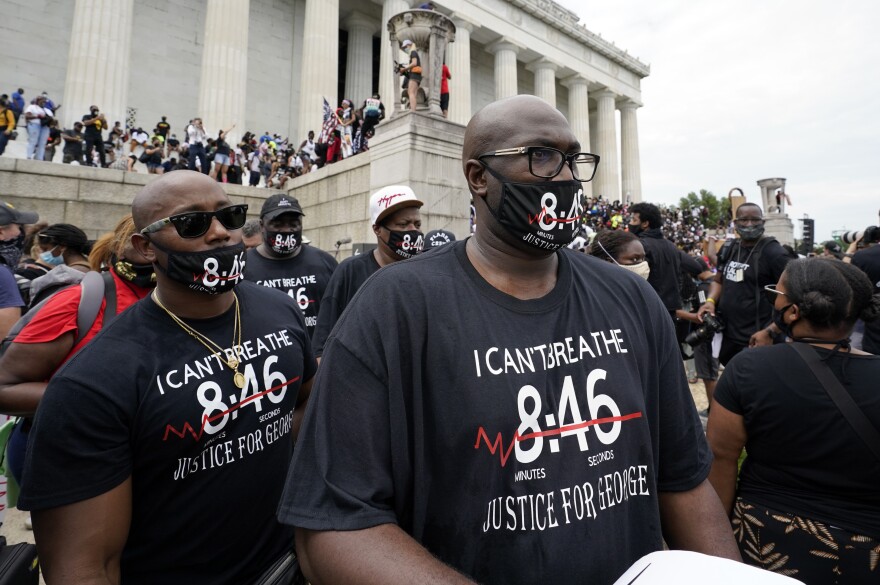 Philonise Floyd, right, brother of George Floyd, gets ready to march from the Lincoln Memorial to the Martin Luther King Jr. Memorial, during the March on Washington on Friday.