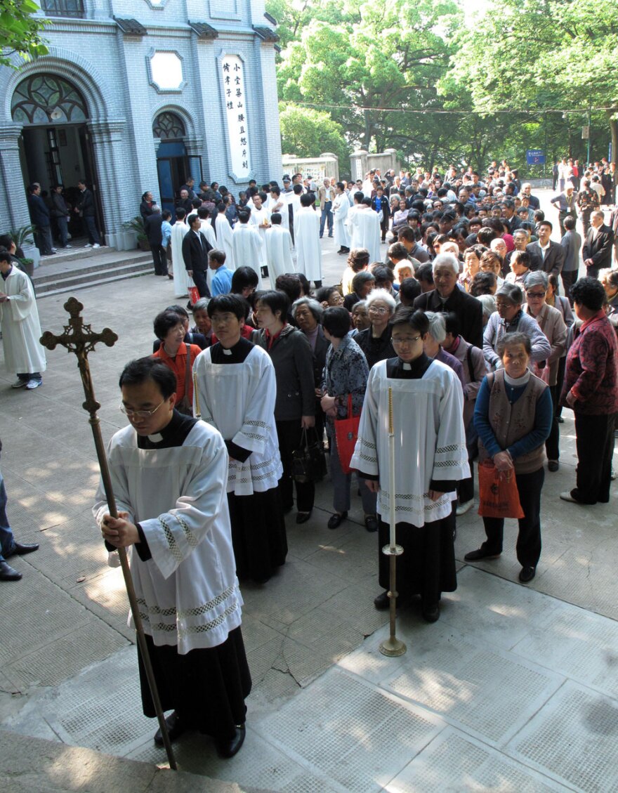 Clergy from the government-sanctioned Catholic church hold a procession up to the Sheshan basilica, on the outskirts of Shanghai. Chinese Catholics, long divided between those who recognize the authority of the Vatican and those who belong to the government-sanctioned church, are beginning the slow process of reconciliation.