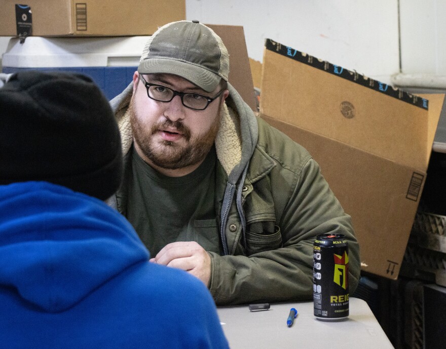 Aurora volunteer Daniel Bell administers the questionnaire of willing participants January 25.