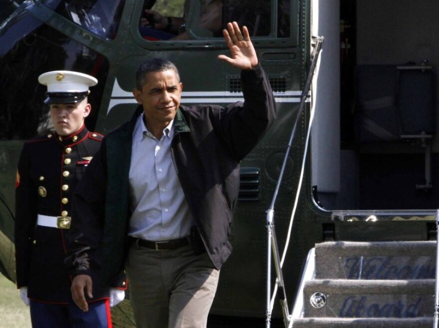 President Barack Obama waves as he exits Marine One on return from Camp David on the South Lawn of the White House in Washington, on Sunday, July 10, 2011.