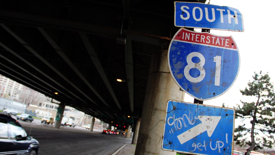 A sign for Interstate 81 sits under an overpass in Syracuse, N.Y. City officials and residents are debating what to do about an aging stretch of the highway that cuts through the city.