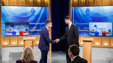 U.S. Rep. Tom Barrett, R-Charlotte, left, and Democratic nominee for U.S. House William Lawrence, right, shake hands at their first head-to-head debate at WKAR's studios in East Lansing, Mich., on Oct. 6, 2026.