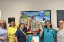 Members of the Woodsdale and Trenton Environmental Resistance group pose for a picture in the city building after submitting a petition seeking to change the city charter to prohibit the construction of data centers over 25 megawatts.