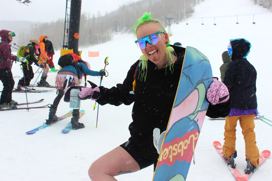 Snowboard instructor and tattoo artist Mandee Middleton from Golden, Colorado gets ready to join the lift line at the base of Sunlight Mountain on March 29, 2024. Middleton was the official tattoo artist for this year’s Boot Tan Fest.