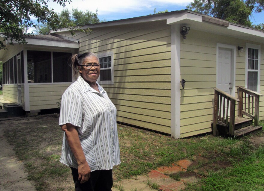 Mississippi resident Ethel Curry stands in front of her East Biloxi home, which was rebuilt with the help of volunteers after Hurricane Katrina.