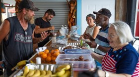 (Left to right) Red, Russ, Pastor Jamie Thompson, Leroy, and volunteer Janice Fladd share breakfast at Anchor United Methodist Church in downtown Wilmington. Leroy makes coffee, helps serve the meals, and cleans up each Sunday. Various volunteer groups provide meals for those experiencing homelessness.