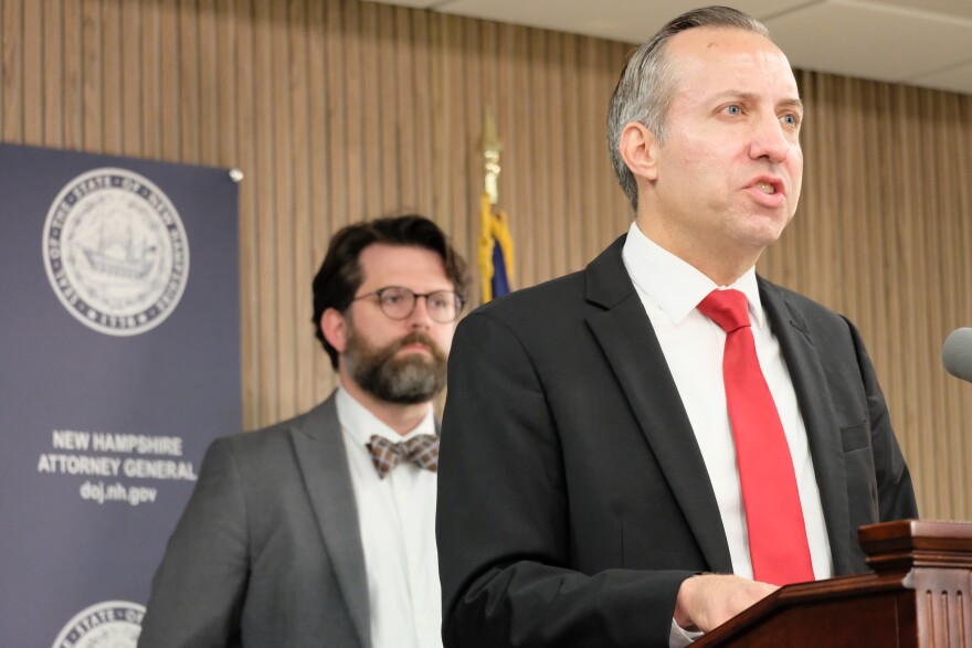 New Hampshire Attorney General John Formella announces the resolution of a case involving NSC-131, a hate group. Sean Locke, head of the state's Civil Rights Unit, is in the background.