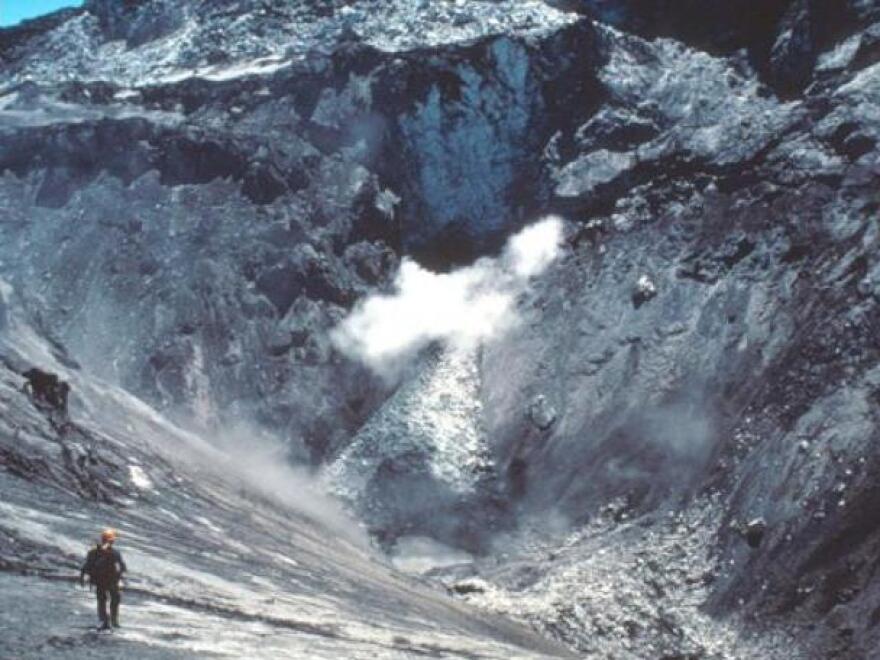 David Johnston enters a small crater at the summit of Mount St. Helens prior to the May 18, 1980, catastrophic collapse and eruption.