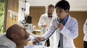 (L-R) Patient Russell Cobb has his pulse listened to by cardiologist Dr. Matt Crim as he works with second year medical student Christopher Rhee while making rounds at Piedmont Athens Regional Medical Center.