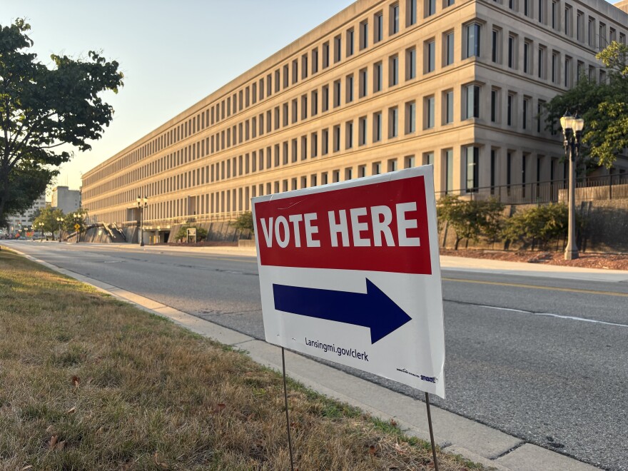 Vote here sign sits outside of a Lansing polling location.