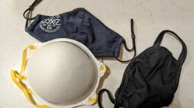 A variety of masks on a white countertop.