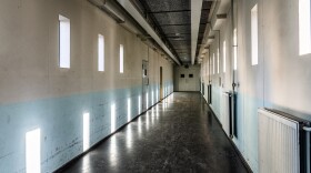 A long bare corridor with light and dark shadow spots