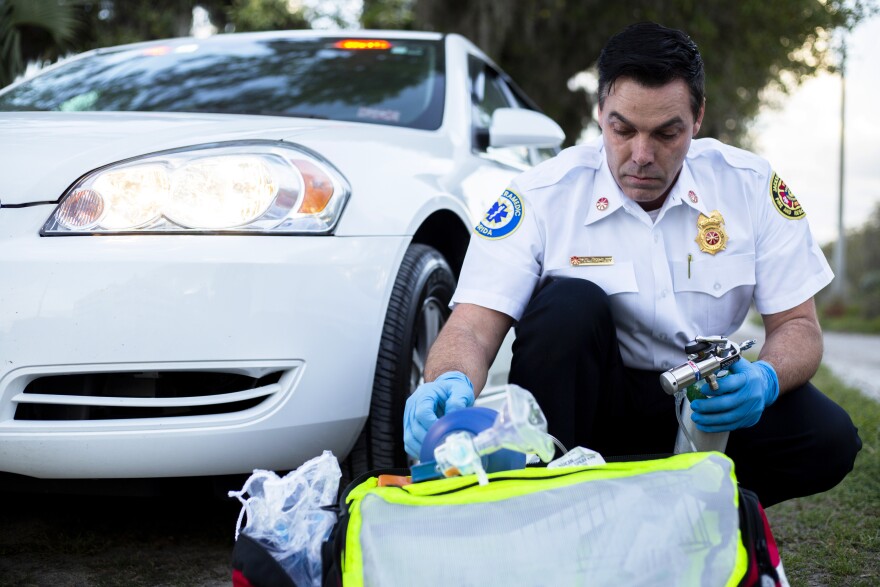 Mark Rowley, a 46-year-old assistant chief with Jacksonville Fire and Rescue Department, takes out the equipment and medicine he would use to treat someone who was overdosing on March 10, 2020, in Gainesville, Fla. (Chris Day/Fresh Take Florida)