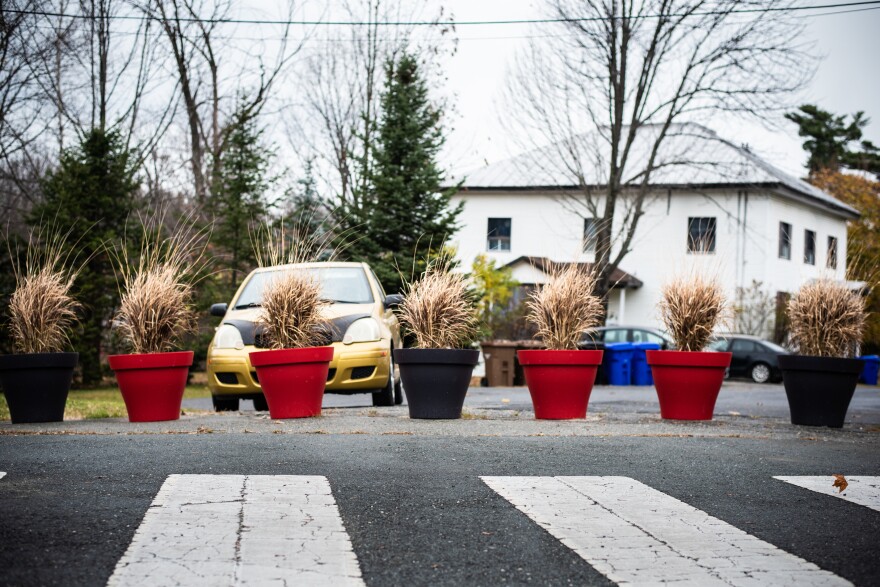 Flower planters delineate the border line and block what was once an open street along the U.S.-Canada international border connecting Stanstead, Quebec, and Derby Line, Vt.
