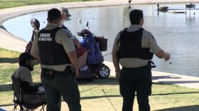 Park rangers speak with visitors at Young Park