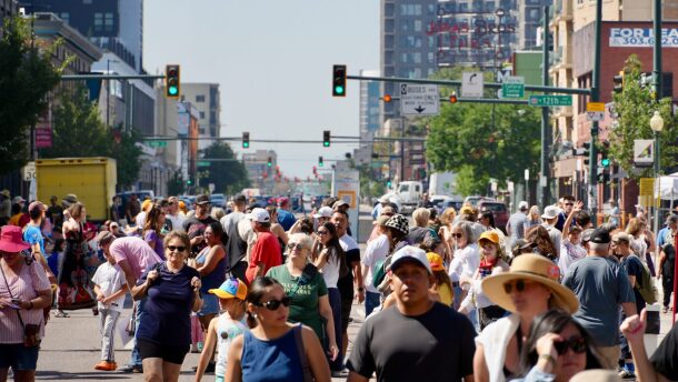 A crowd of people walking in the downtown streets of Denver.