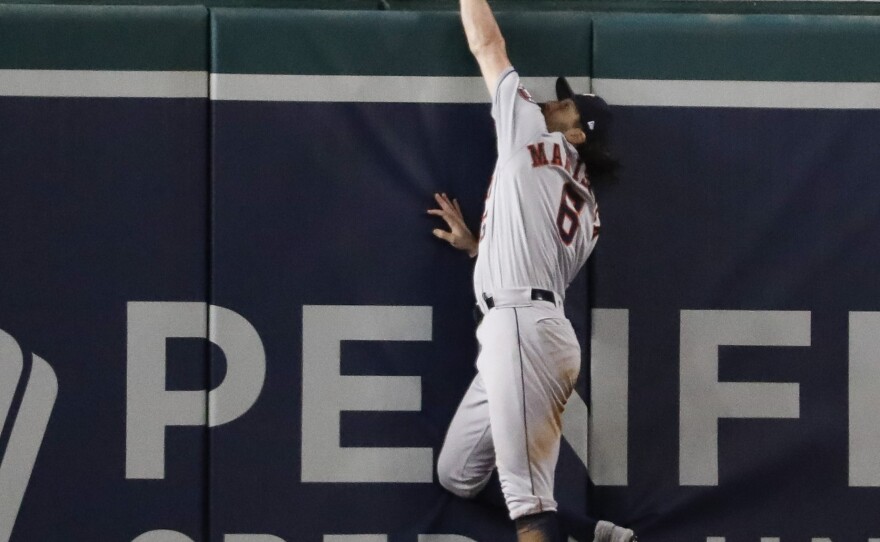 Houston Astros center fielder Jake Marisnick can't get a glove on a home run by Washington Nationals' Juan Soto during the seventh inning of Game 5 of the World Series.