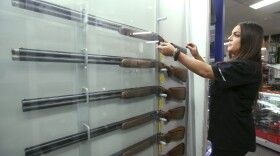 Salesperson Lauren Ungari handles a firearm at a display in a gun shop in Sydney, Australia, Wednesday, Oct. 4, 2017. Former Australian Deputy Prime Minister Tim Fischer, who helped win over a hostile Australian pro-gun lobby to the idea of massive weapons reform says the overwhelmingly success of the change should serve as an example for American politicians in the wake of the Las Vegas massacre. (Rick Rycroft/AP)